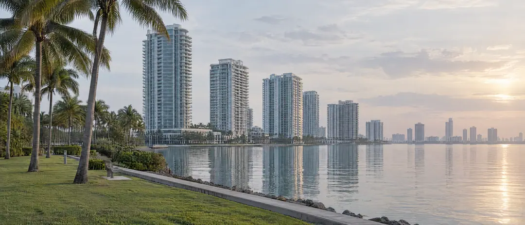 Slender bayfront residential towers in Edgewater seen across a waterfront park and Biscayne Bay